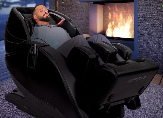 A client reclining, eyes closed, in the sound healing massage chair